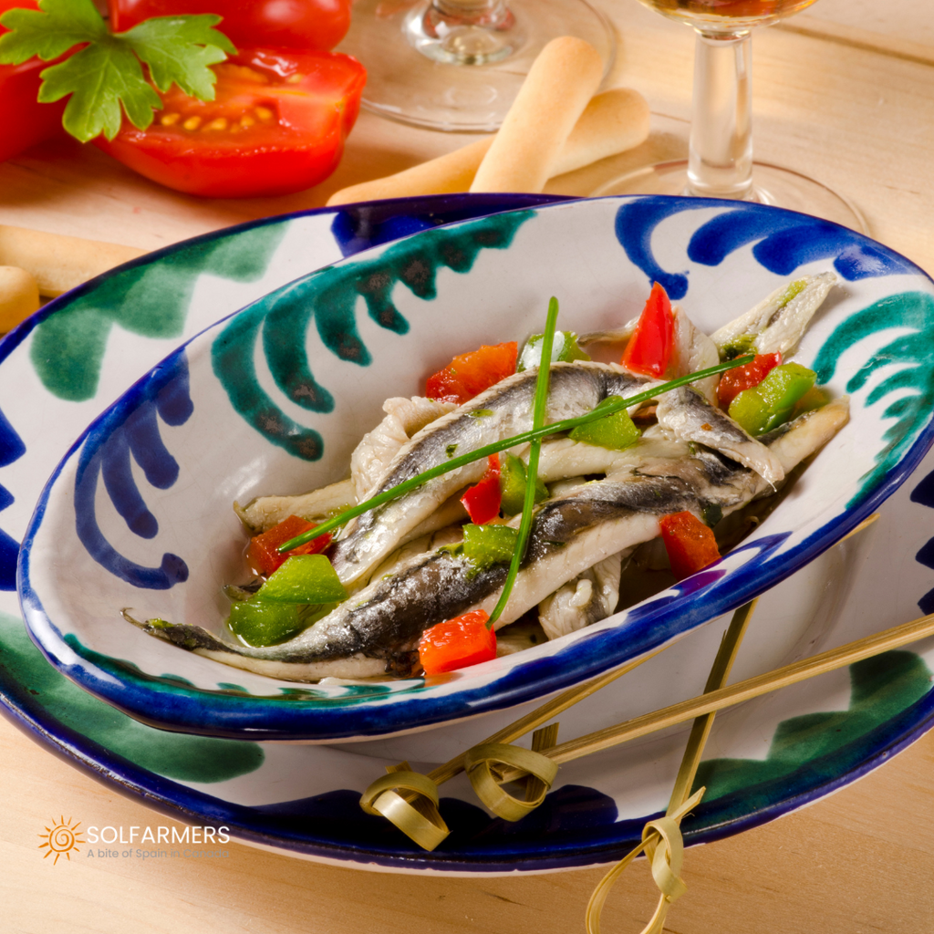 Dish of boqueron white anchovies and anchovies,marinated in vinegar, golden anchovies, roasted peppers and fresh parsley. Gastronomic presentation of Spanish cuisine in Canada.