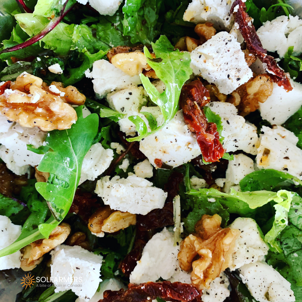 salad made with greens, balsamic vinegar, olive oil and nuts